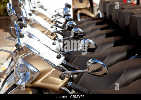 bikes scooter motorbikes detail in a row on a renting house Stock Photo