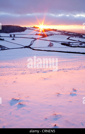 Sunset over a snow covered hillside near Bath. Stock Photo