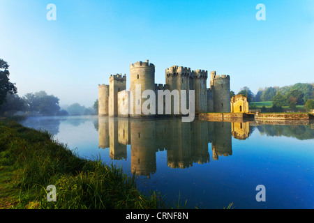 Bodiam Castle, an almost perfect example of a 14th century medieval castle, reflected in the moat at dawn. Stock Photo