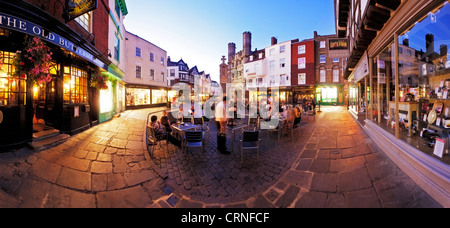 Panoramic view of people eating and drinking outside The Old Buttermarket in Canterbury. Stock Photo