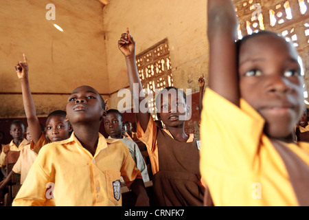 Grade three students raise their hands to answer their teacher's question during a mathematics class at the Wilberforce primary Stock Photo