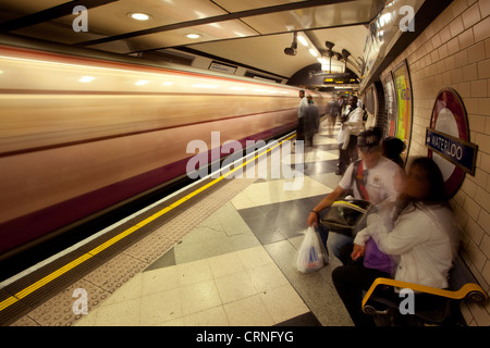 A Northern line tube train passing through Waterloo underground station. Stock Photo