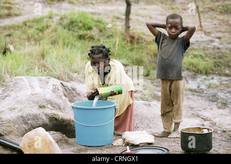 Fetching water in the refugee camp Galangue Unita. Stock Photo