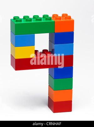 Coloured plastic building bricks in the shape of the number 9 Stock Photo