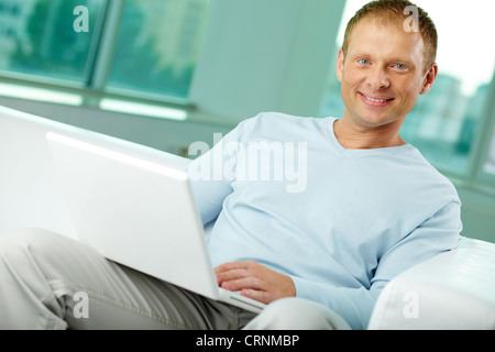 Portrait of a positive-looking man using modern technology Stock Photo