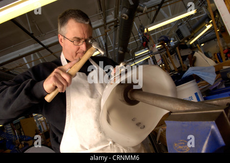 A prosthesis technician rivets a polypropylene socket to comfortably fit a patient's stump. Stock Photo