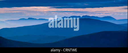 Mountain fog in the valleys of the western Lake District overlooked by the highest peak, Scafell Pike. Stock Photo