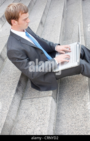 Business man sitting on stairs outdoor Stock Photo