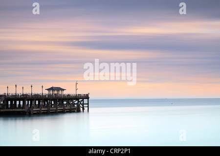 The Victorian pier at Swanage, jutting out into the sea, in early morning light. Stock Photo