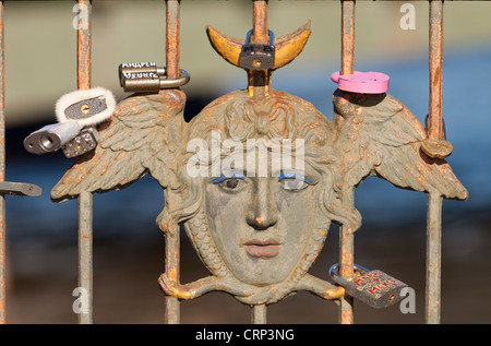 Mask of Medusa the Gorgon. Element of the Three-Arched Bridge railing with locks St. Petersburg, Russia Stock Photo