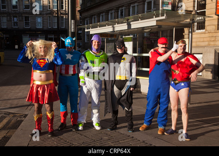 A group of men dressed as super heros and animated characters on a stag weekend. Stock Photo