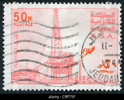 Postage stamps printed in The Kingdom of Saudi Arabia (KSA), shows the oil derrick in Al Khafji, circa 1977 Stock Photo