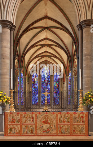 High Altar in Salisbury Cathedral with embroidered cloth and the stained glass window of Trinity Chapel in the background. Stock Photo