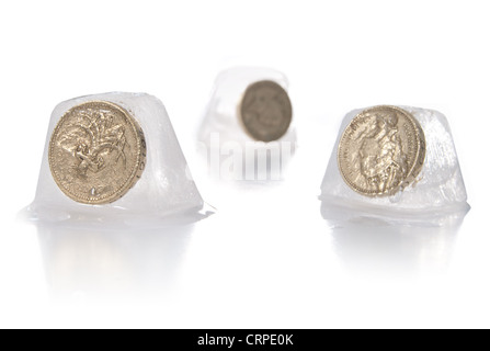 Frozen assets, pound coins inside ice cubes Stock Photo