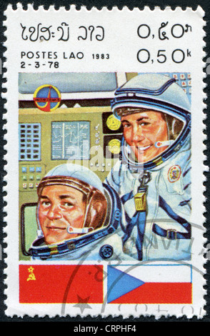 A stamp printed in the Laos, a symbol INTERCOSMOS - Space Cooperation Program of the USSR - Czechoslovakia, circa 1983 Stock Photo