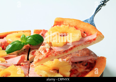 Serving fresh baked Pizza Hawaii Stock Photo