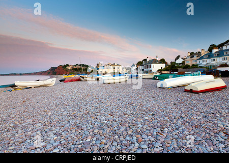 Small boats on the pebble beach at Budleigh Salterton on the South coast of Devon by the English Channel. Stock Photo