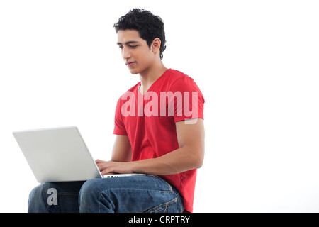 Young man using laptop over white background Stock Photo