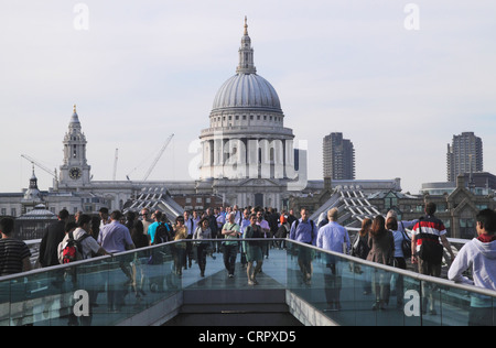 People walking over Millennium Bridge London Stock Photo