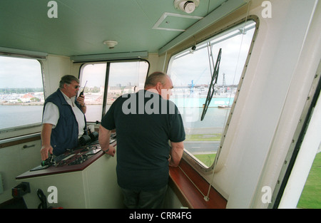 Captain and harbor pilot on the bridge of a ship Stock Photo