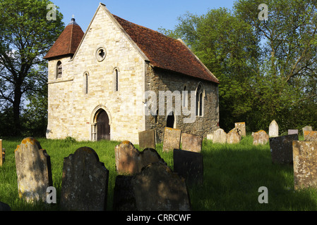 Village church in grave yard on a warm day Stock Photo