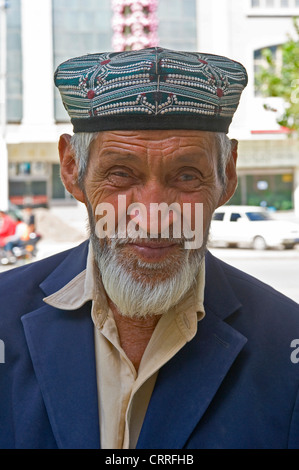 the portrait of an Uyghur man wearing a doppa hat, Kashgar, Xinjiang ...