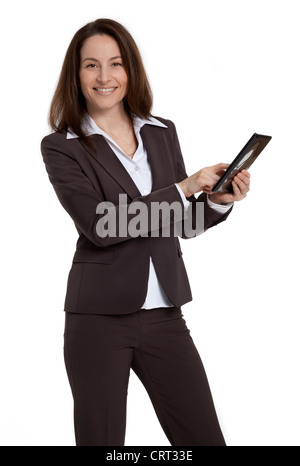 Attractive mid-forties businesswoman standing, using tablet device, on white background. Stock Photo