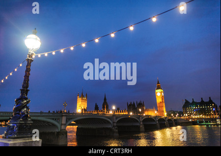 LONDON, United Kingdom — Westminster Bridge at dusk, with the iconic Westminster Palace in the background, creates a picturesque scene along the River Thames. The historic bridge and the illuminated silhouette of the Houses of Parliament, including Big Ben, reflect beautifully on the water. This enchanting view captures the essence of London’s architectural grandeur and timeless beauty. Stock Photo