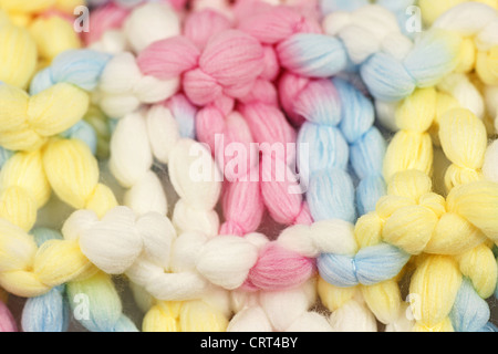 Macro shot of knitted colorful pastel or baby color wool or yarn, great baby, arts and crafts or texture abstract background. Stock Photo