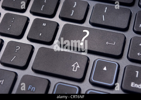 concepts of questions or computer errors, with a question on enter key of keyboard. Stock Photo