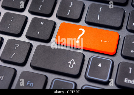 concepts of questions or computer errors, with a question on enter key of keyboard. Stock Photo