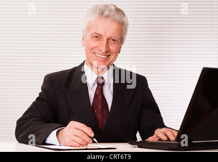 senior businessman with laptop on white background Stock Photo