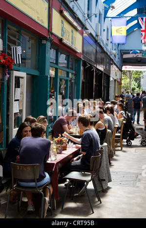 Patrons at a cafe in Brixton Village, Brixton Market Stock Photo