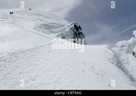 Alpine climbers high on the Bosses ridge of Mont Blanc Stock Photo
