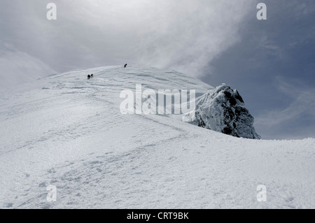 Alpine climbers high on the Bosses ridge of Mont Blanc Stock Photo