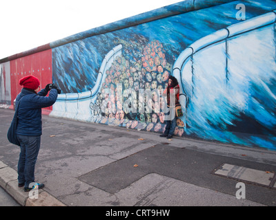 Tourists taking pictures by  Berlin wall Stock Photo