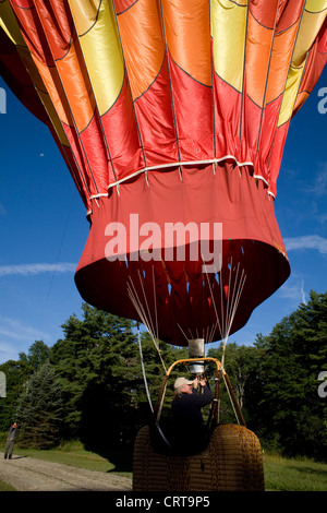 Hot air balloon pilot prepares to deflate balloon after landing in western Massachusetts. Stock Photo