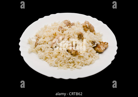 Pilaf on plate - the dish of asian cuisine. Isolated on black background Stock Photo