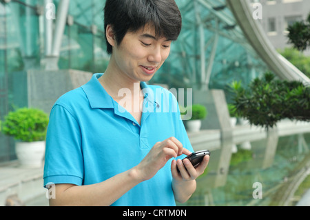 asian man texting Stock Photo