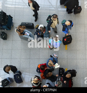 Air travelers wait at the check-in desk Stock Photo