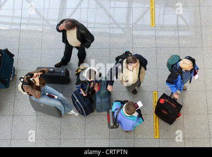 Air travelers wait at the check-in desk Stock Photo