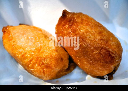 Inari Sushi or Inarizushi is a japanese snack made of a thin tofu roll filled with Sushi Rice Stock Photo