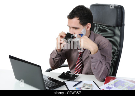Businessman shaves in the workplace Stock Photo