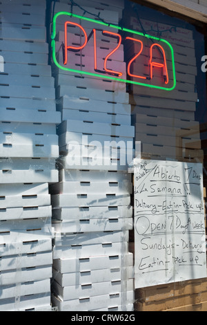 Pizza boxes stacked in window of a restaurant in Reading, Pennsylvania Stock Photo