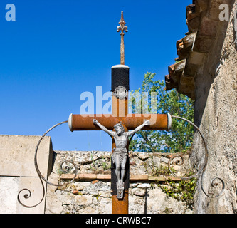 Statue of Jesus on rusting cross in graveyard of medieval mountain village of Claviers Var Provence France Europe Stock Photo