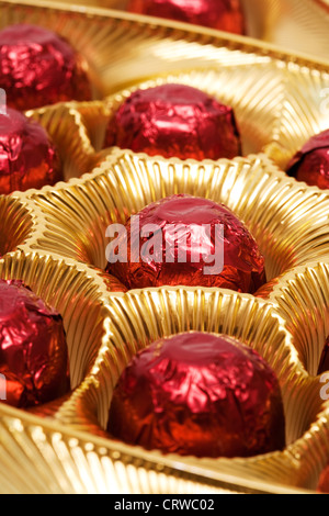 Chocolates in a red foil Stock Photo