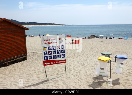 Rubbish bins and facilities information sign on beach at Vila Praia de Ancora , near Caminha , Minho Province, northern Portugal Stock Photo