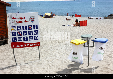 Rubbish bins and facilities information sign on beach at Vila Praia de Ancora , near Caminha , Minho Province, northern Portugal Stock Photo