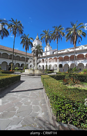 Courtyard gardens, fountain and dome of the church and monastery of San Francisco in Quito, Ecuador Stock Photo