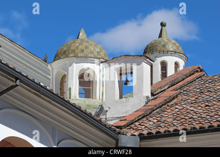 Close-up of domes and a bell from the courtyard of the church and monastery of San Francisco in Quito, Ecuador Stock Photo